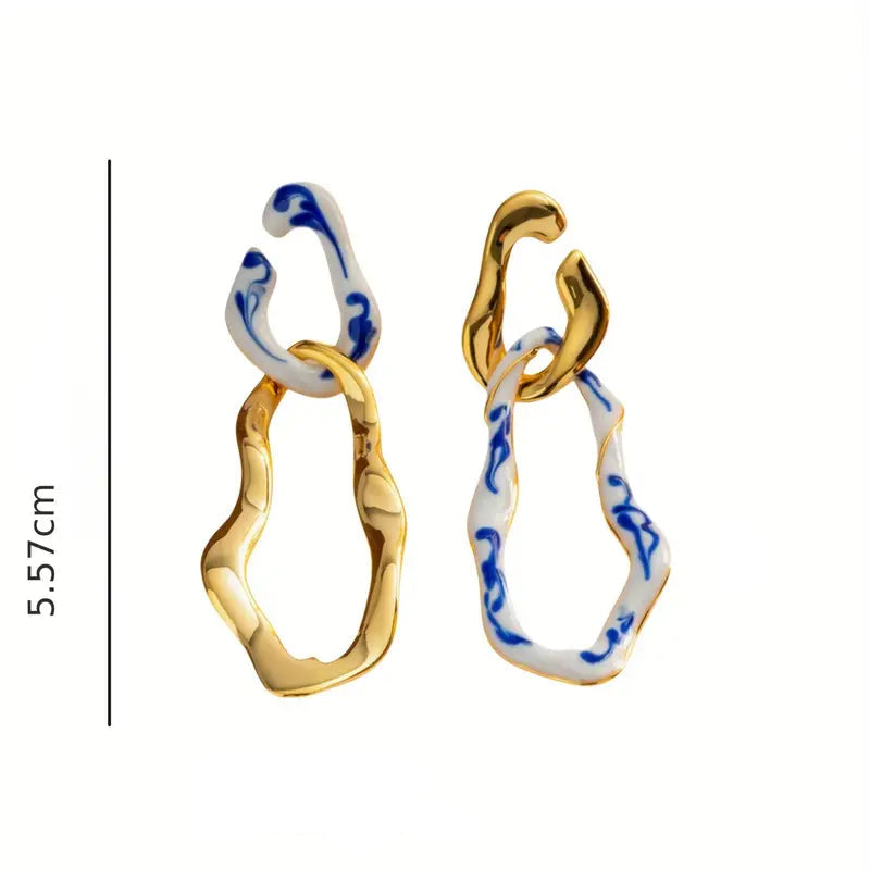 Gold and blue ceramic earrings with measurements on a white background