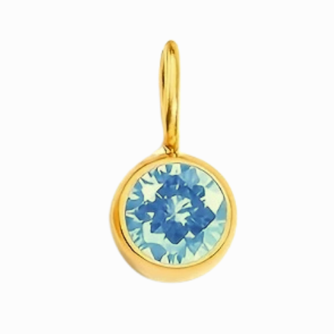 Gold earring with blue gemstone on a white background