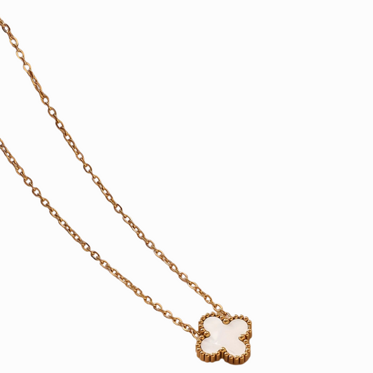 gold necklace with a pendant on a white background