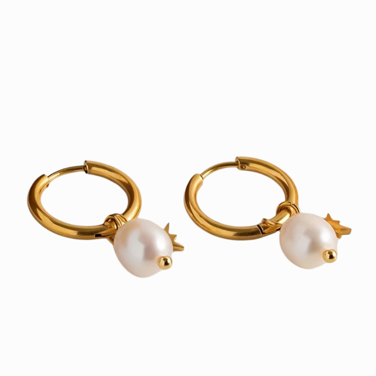 Gold hoop earrings with pearl drops on a white background