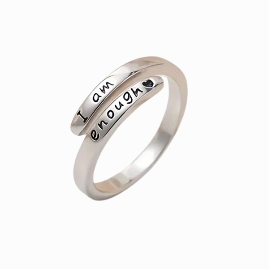 Silver ring with engraved text on a white background
