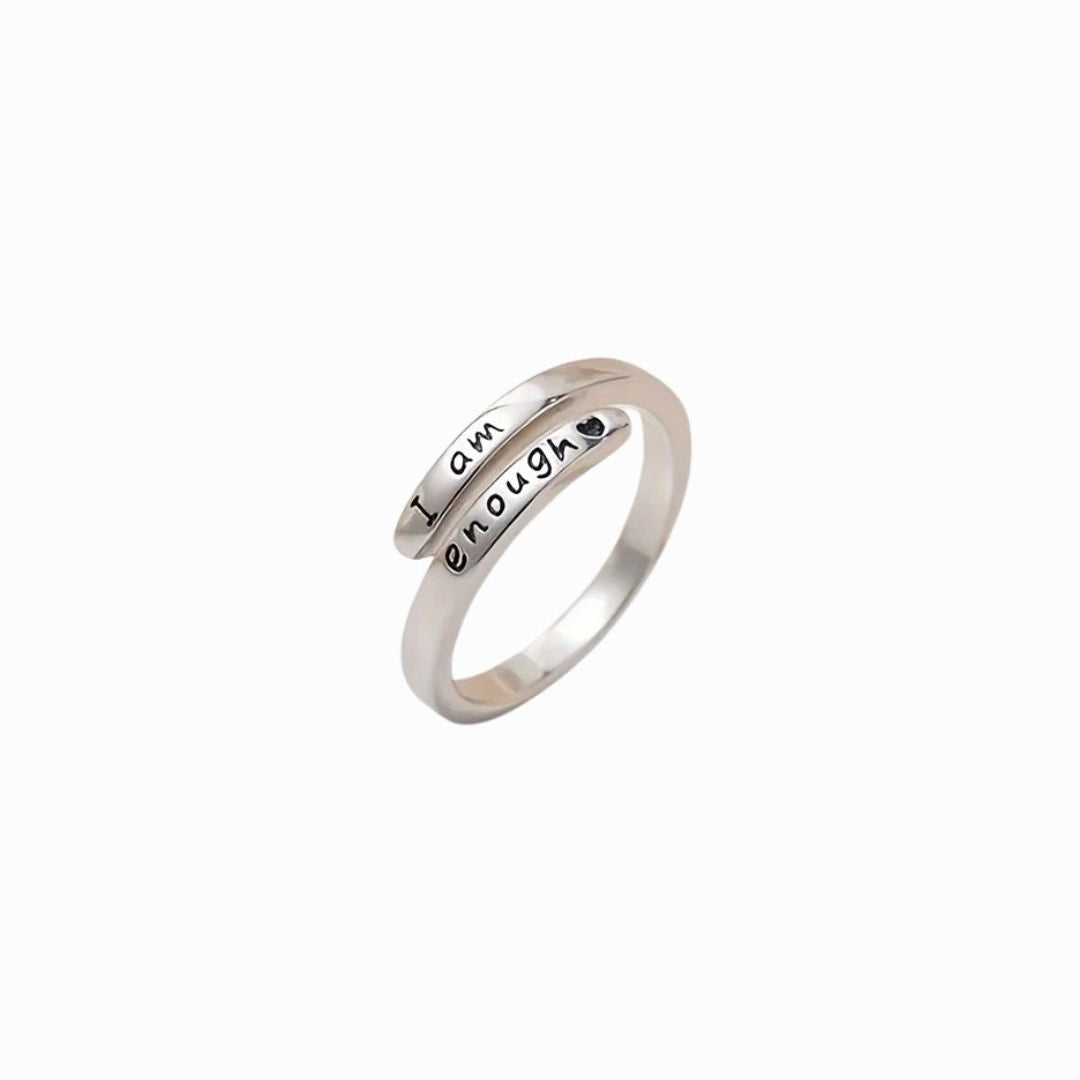 Silver ring with 'I am enough' engraving on a white background