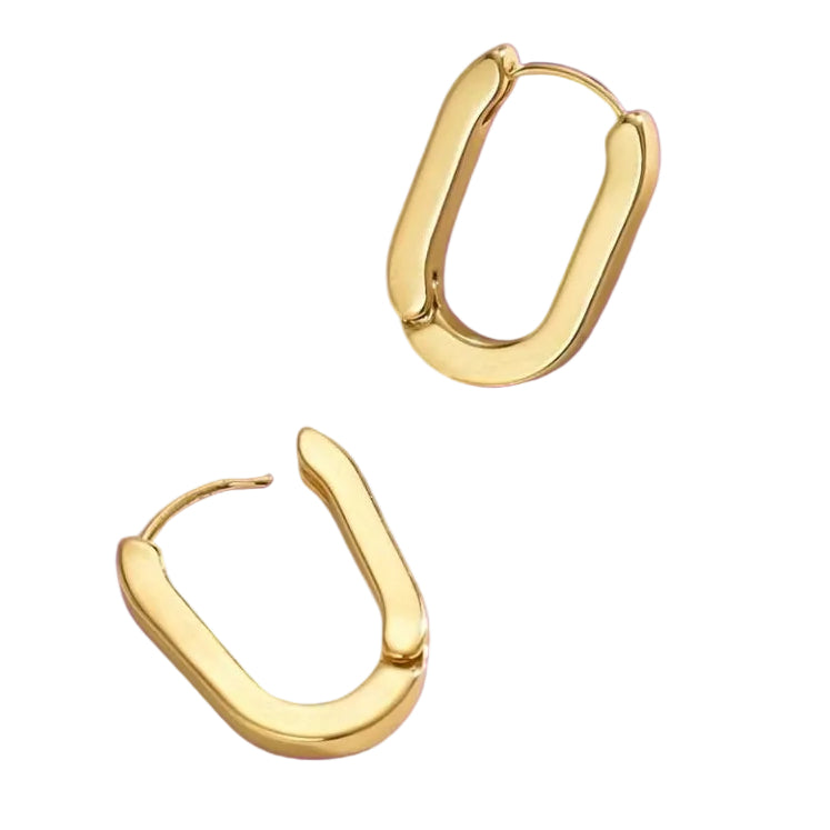 Gold hoop earrings on a purple background