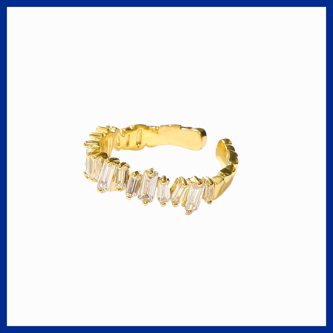 Gold ring with baguette cut stones on a white background