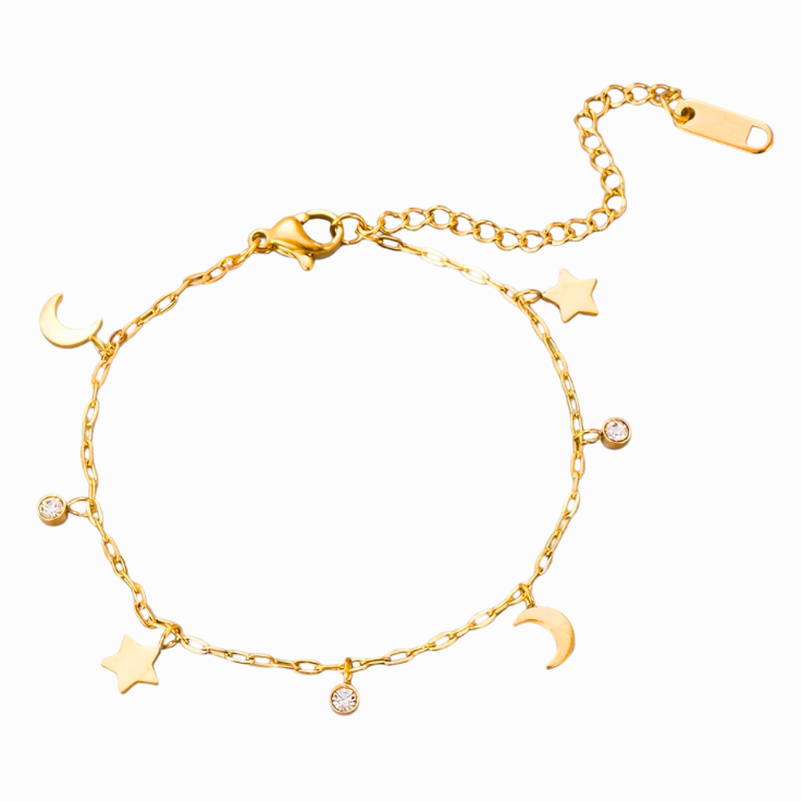 Gold bracelet with star and moon charms on a white background