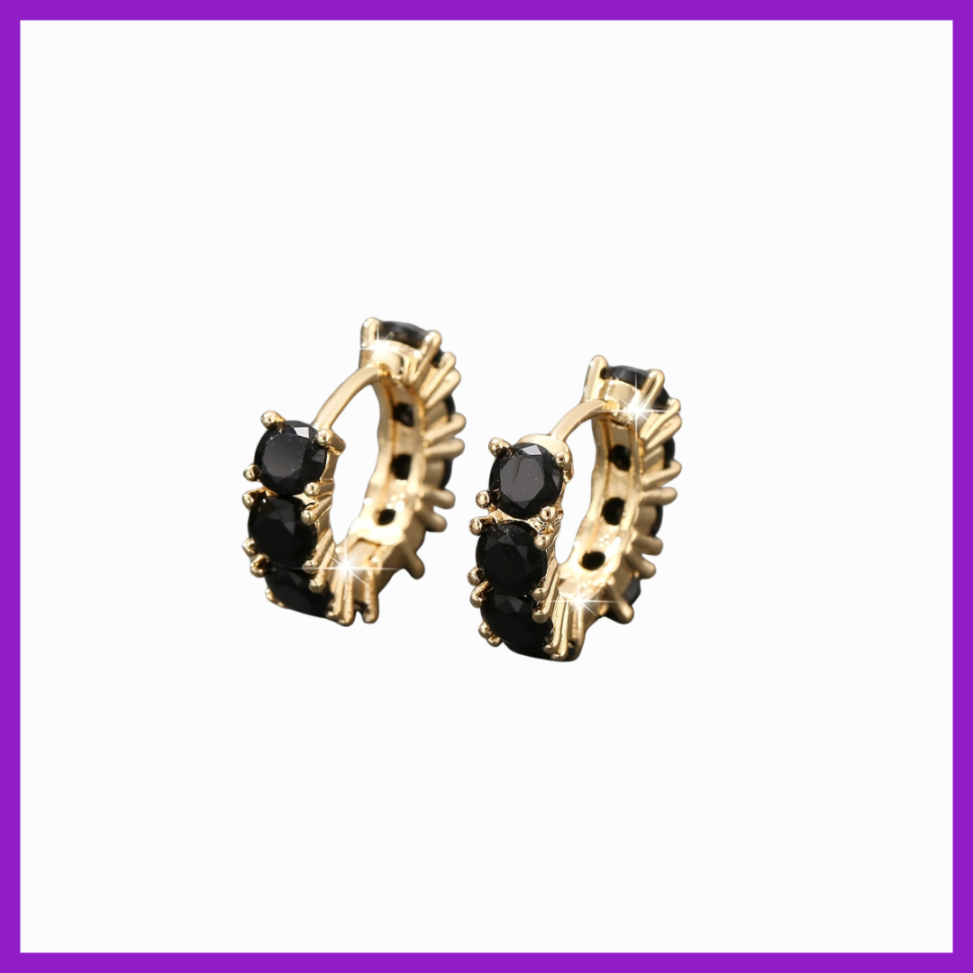 Gold hoop earrings with black gemstones on a white background
