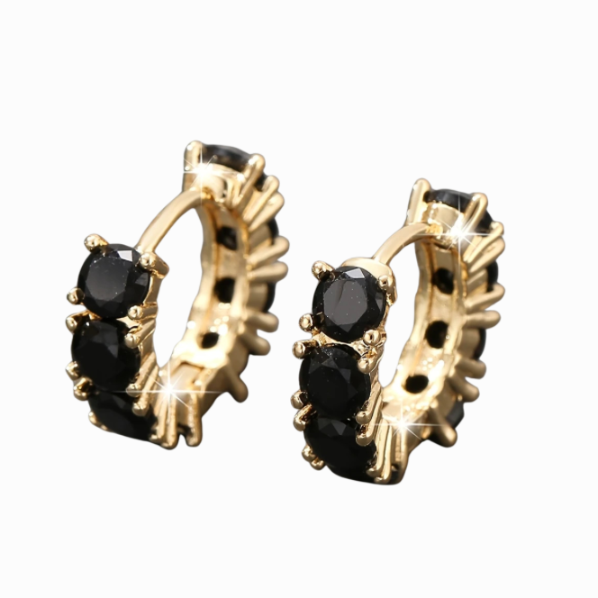 Gold hoop earrings with black gemstones on a white background