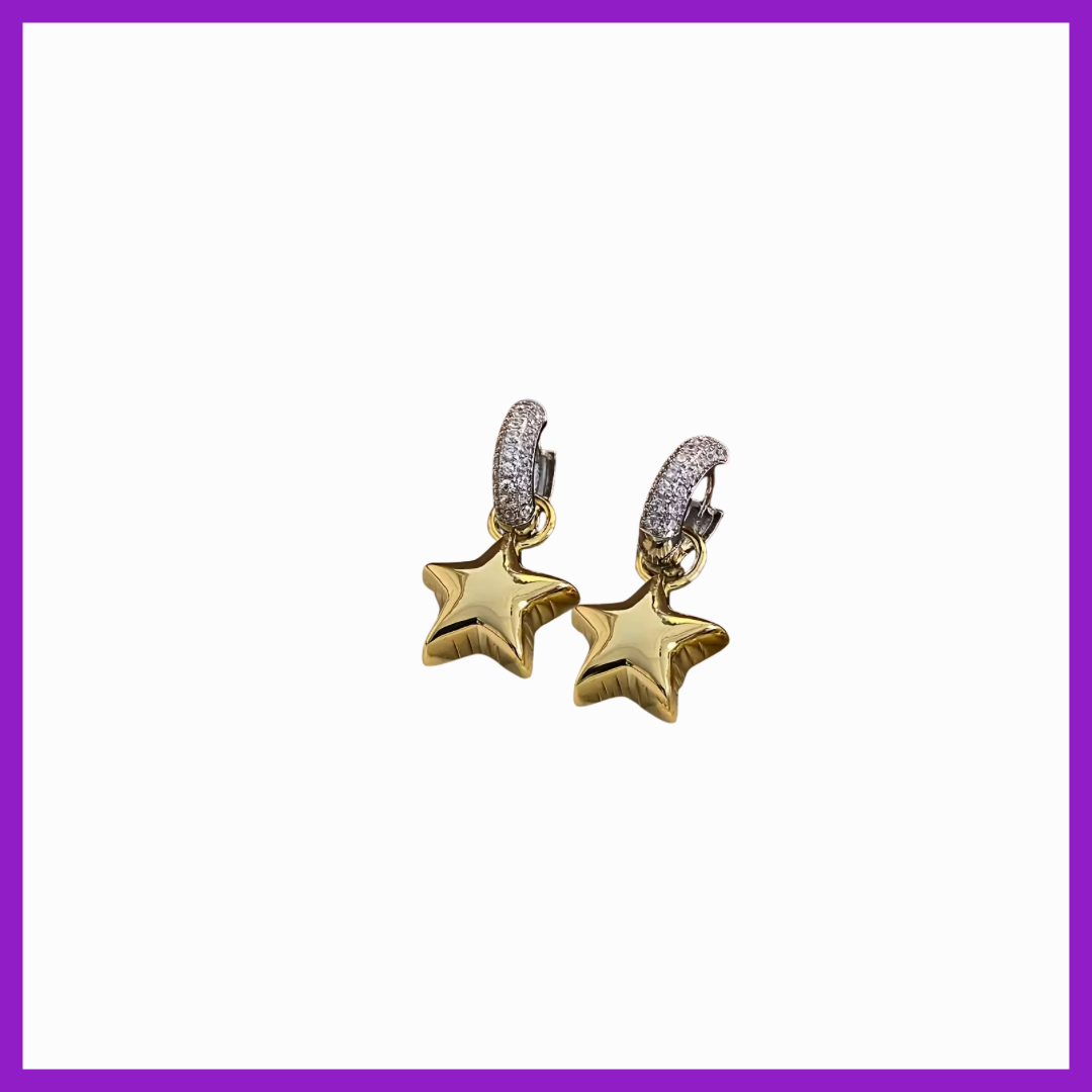 Gold star-shaped earrings with diamond accents on a white background