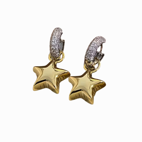 Gold star-shaped earrings with diamond accents on a white background