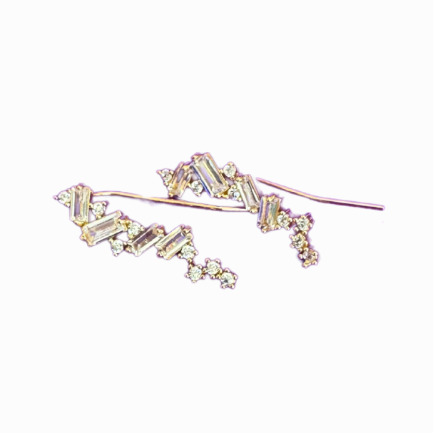 Pair of gold earrings with clear stones on a white background