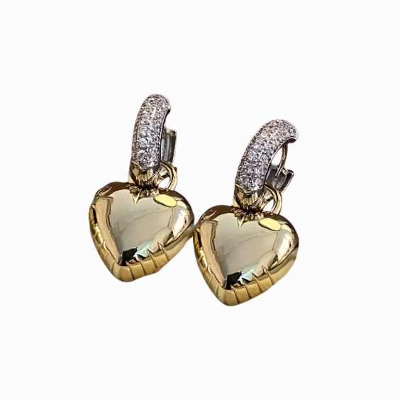 Heart-shaped earrings with gold and clear gemstones on a white background