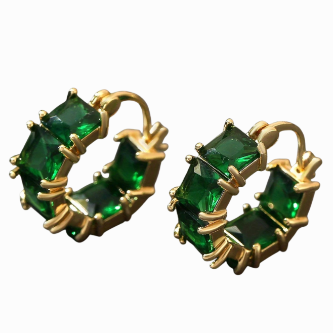 Gold hoop earrings with green gemstones on a white background