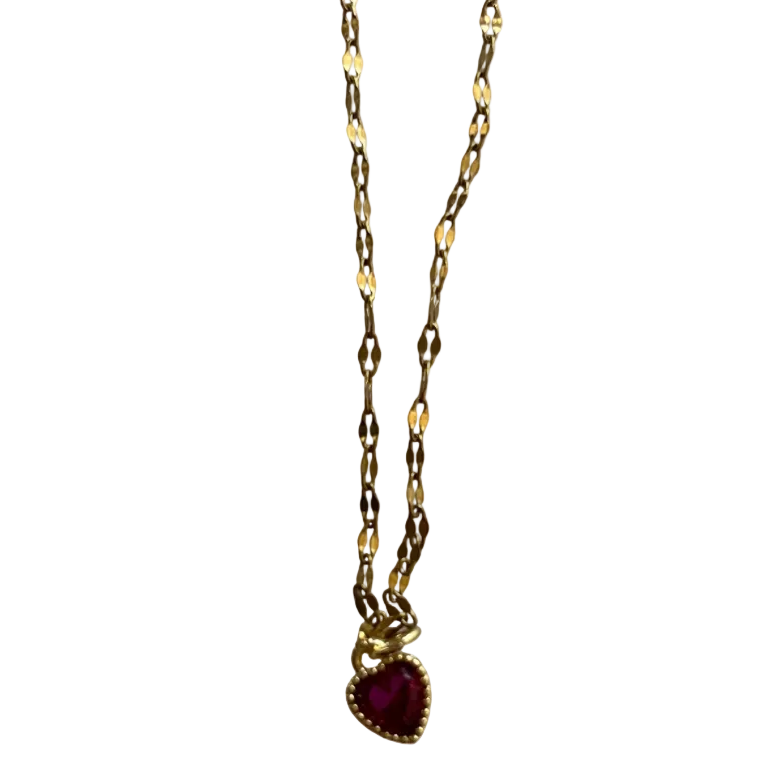 Gold necklace with a red pendant on a white background