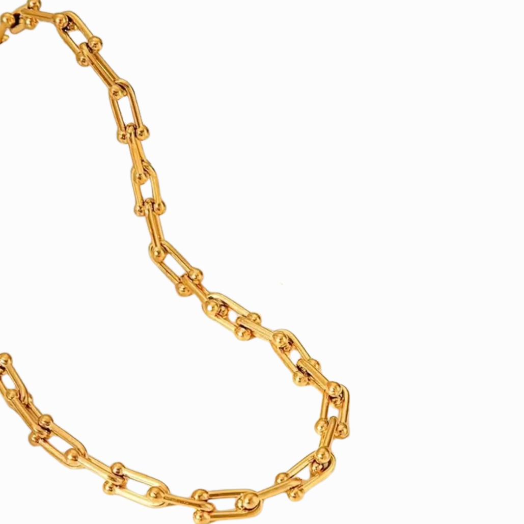 Gold chain necklace on a white background
