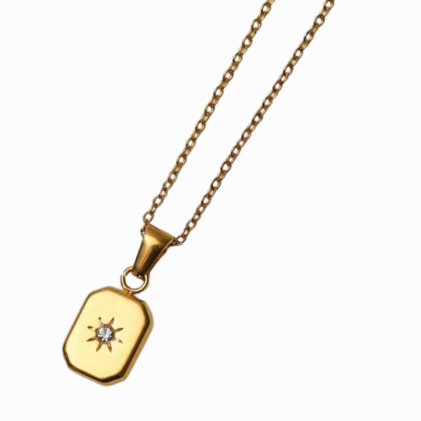 Gold necklace with a pendant on a white background