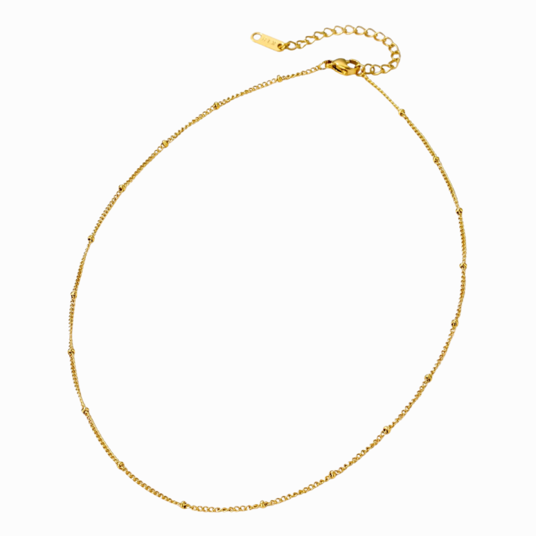Gold necklace on a white background with a teal border