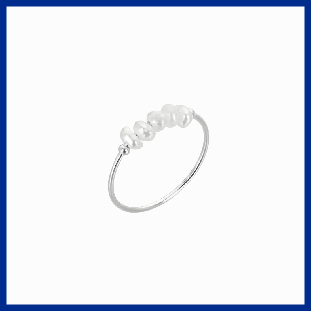 Silver ring with pearls on a white background