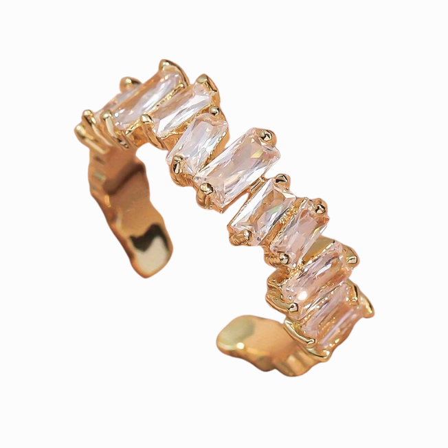 Gold earring with clear gemstones on a white background