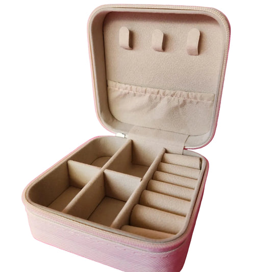 Beige jewelry case with compartments on a pink background