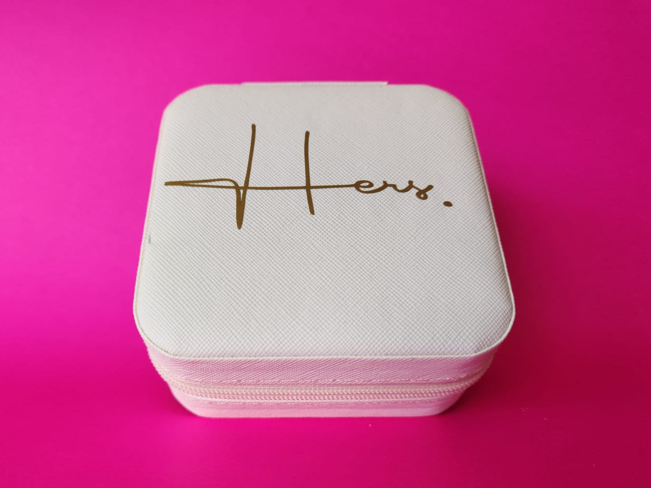 White jewelry box with 'Hers' engraving on a pink background