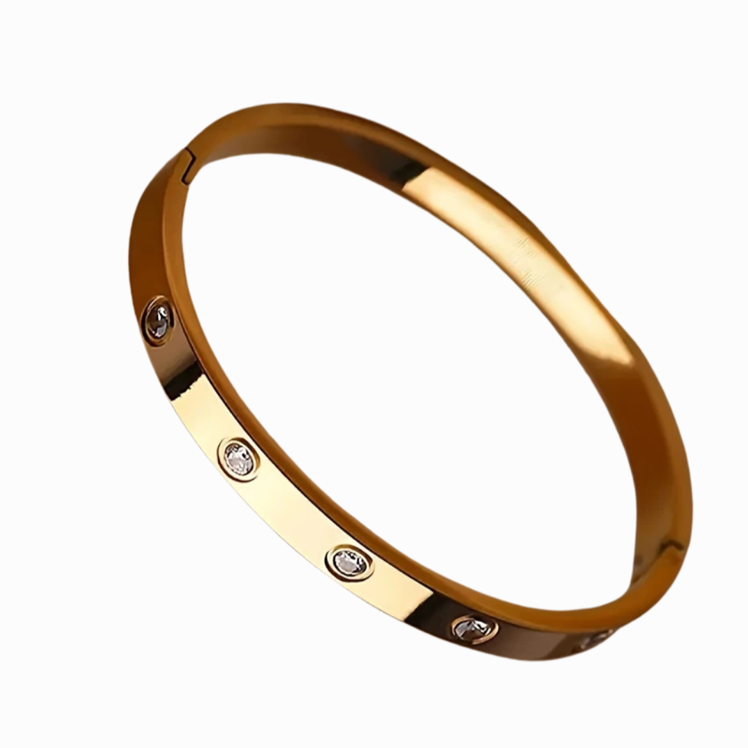 Gold bracelet with embedded diamonds on a white background