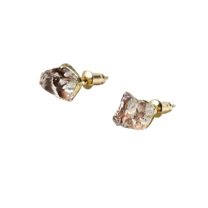 A pair of chalcedony gemstone stud earrings with gold-colored metallic accents, displayed against a light background.