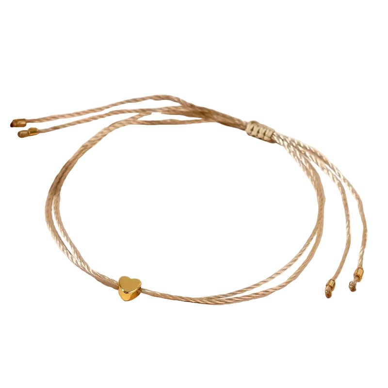A handcrafted boho chic braided bracelet with mini love heart beads in an elegant golden color, displayed on a neutral background.