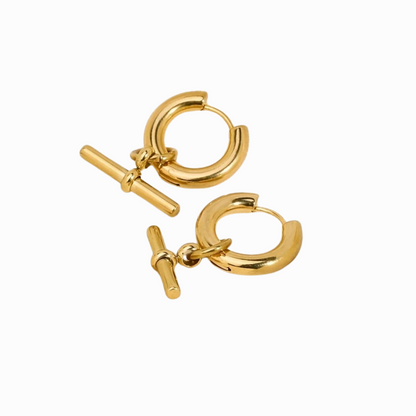 Pair of gold hoop earrings with a clasp on a white background
