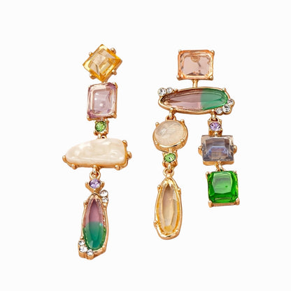 Multicolored gemstone earrings with gold accents on a white background