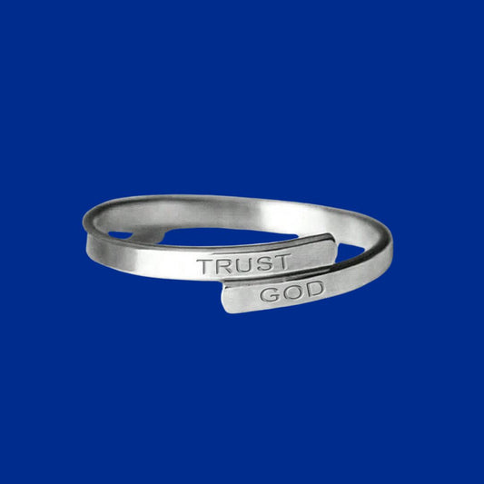 Silver ring with 'Trust God' engraving on a blue background