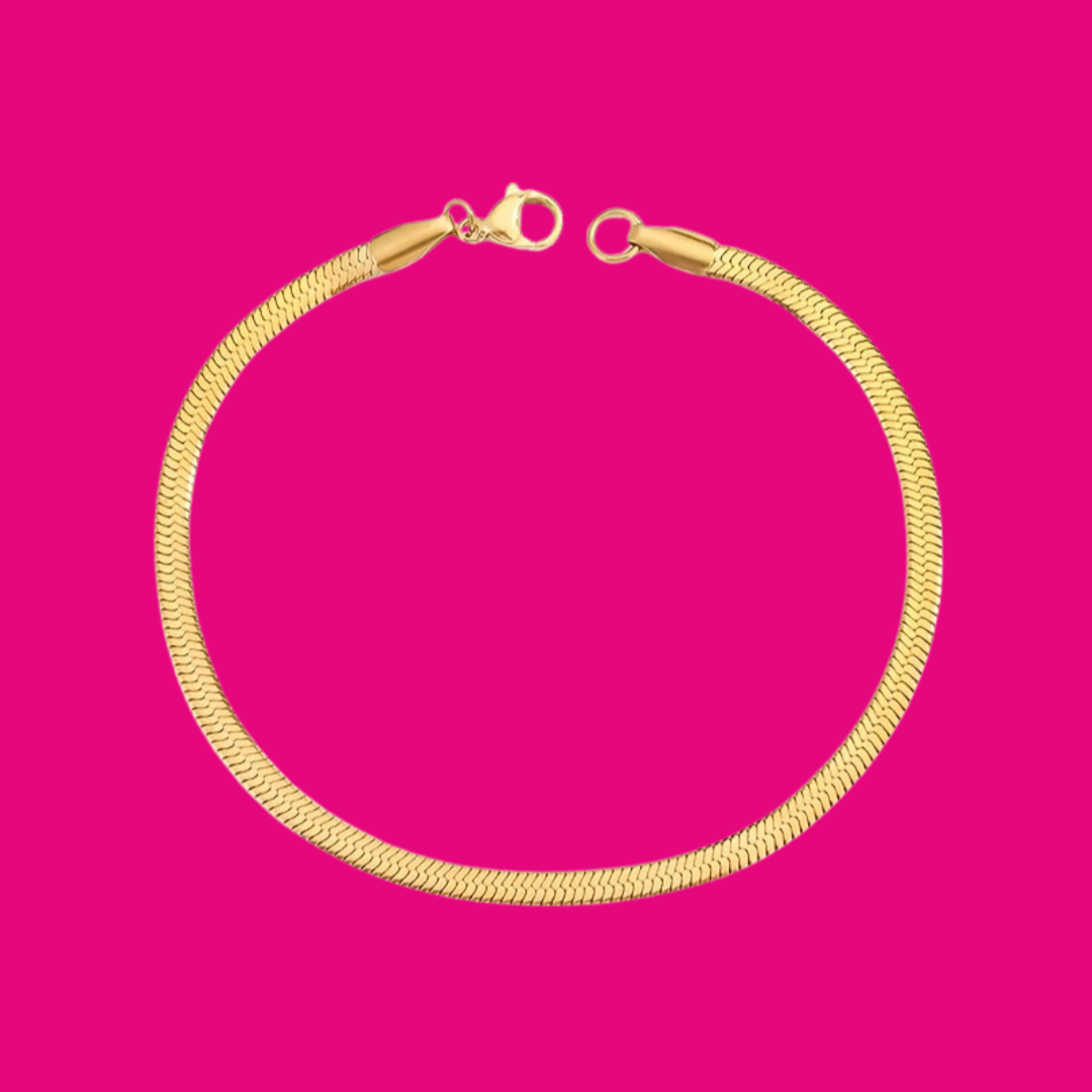 Gold bracelet on a pink background