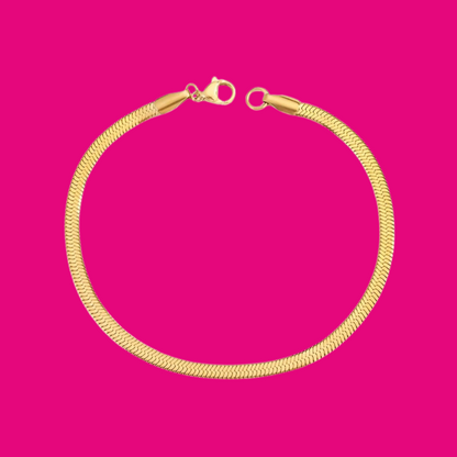 Gold bracelet on a pink background