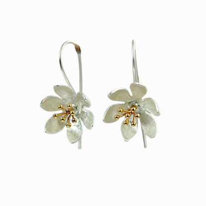 Floral earrings with gold accents on a white background