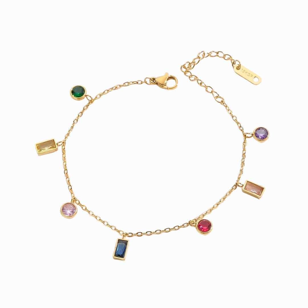 Gold bracelet with colorful gemstones on a white background