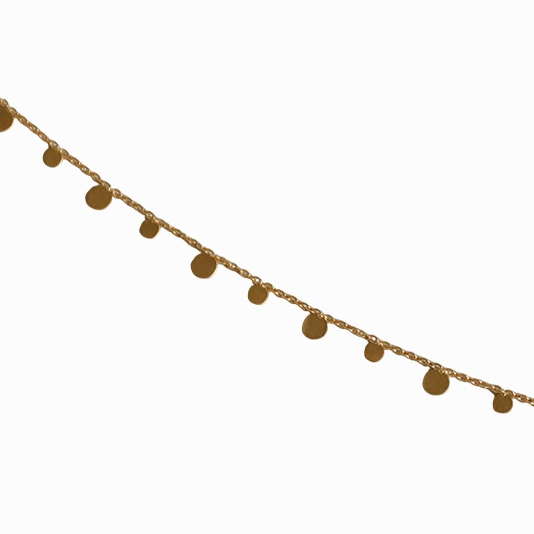 Gold chain with round pendants on a white background