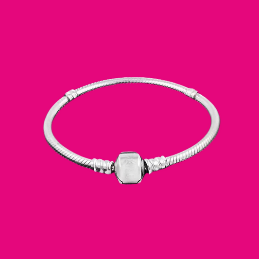 Silver bracelet with a hexagonal clasp on a pink background