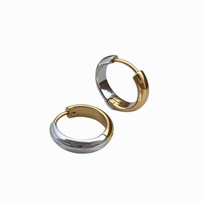 Two-tone hoop earrings, gold and silver, on a white background