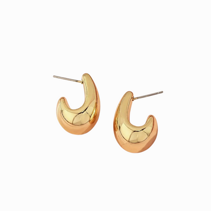 Gold hoop earrings on a white background