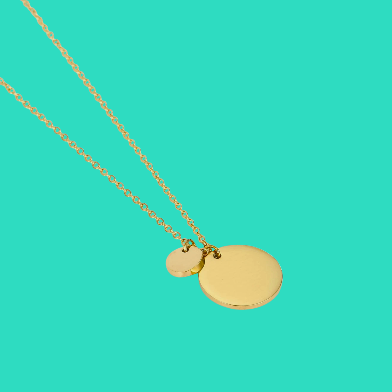 14k gold-plated necklace with two round pendants on a teal background