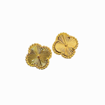 Pair of gold earrings on a white background