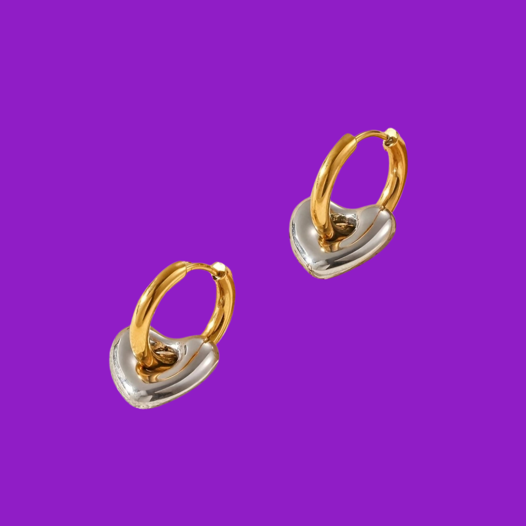 Gold and silver hoop earrings on a purple background