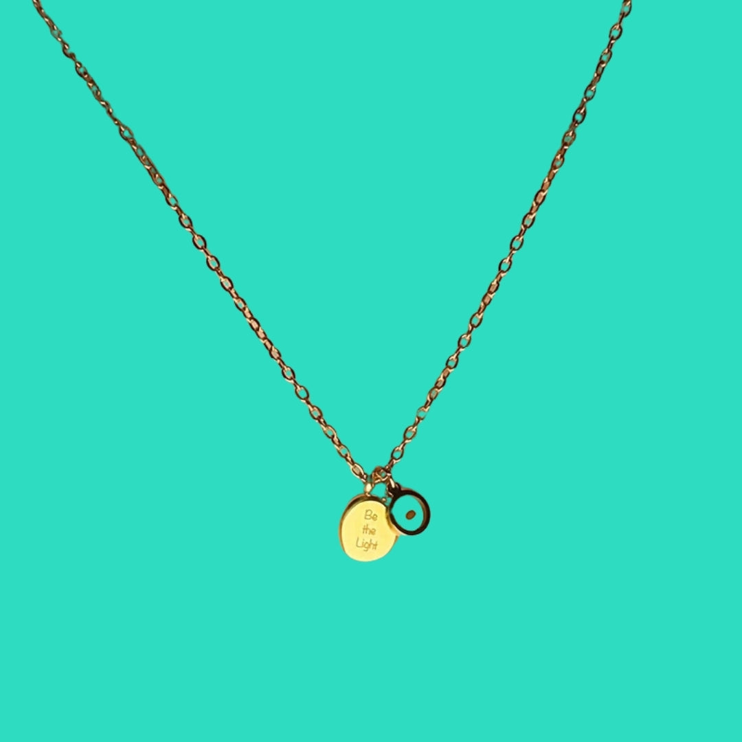 Necklace with a gold pendant on a turquoise background