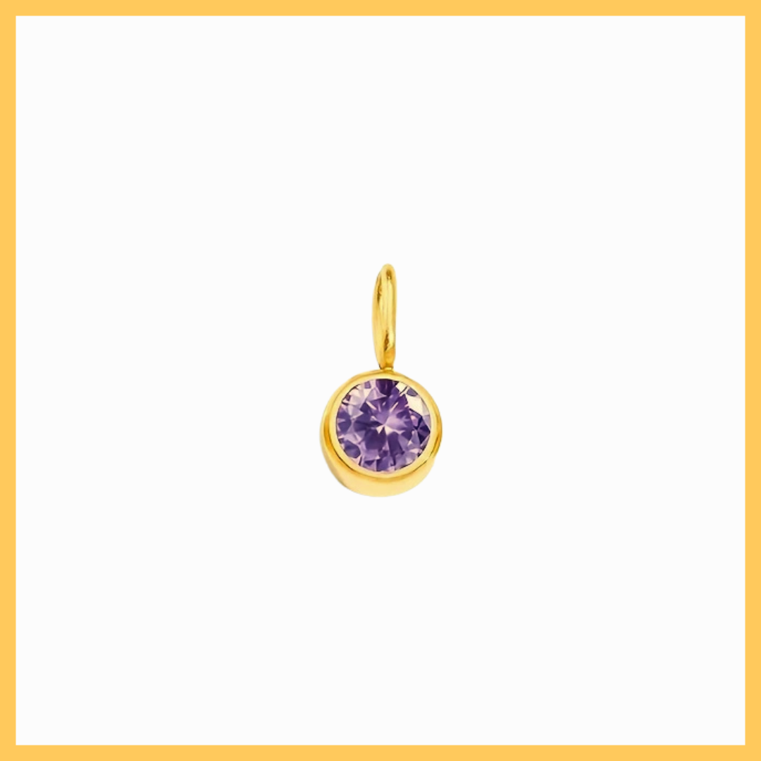 Gold pendant with a purple gemstone on a white background