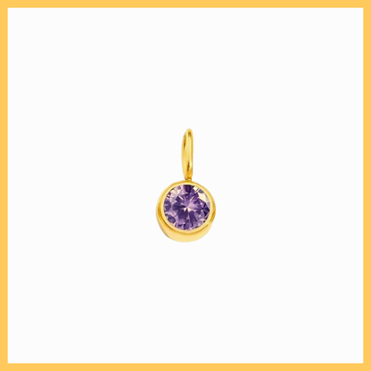 Gold pendant with a purple gemstone on a white background