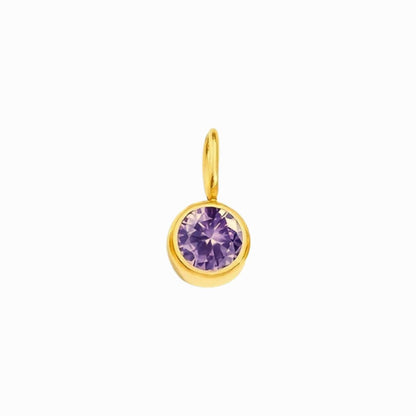 Gold pendant with a purple gemstone on a white background
