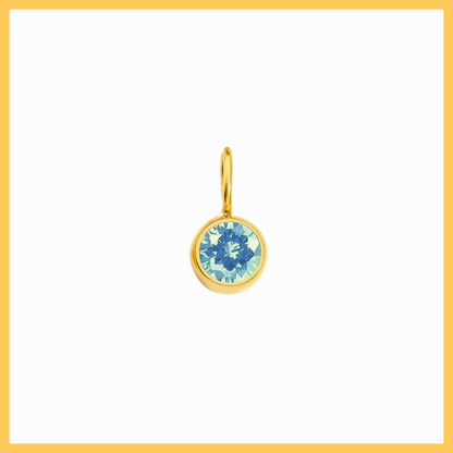 Gold earring with blue gemstone on a white background