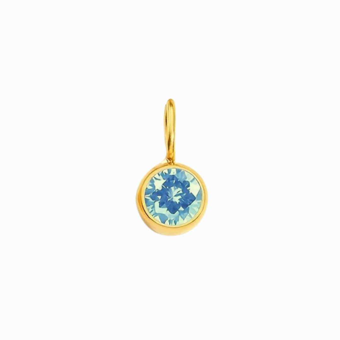 Gold pendant with a blue gemstone on a white background