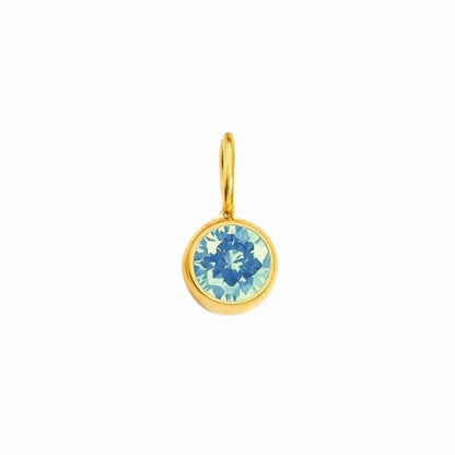 Gold pendant with a blue gemstone on a white background