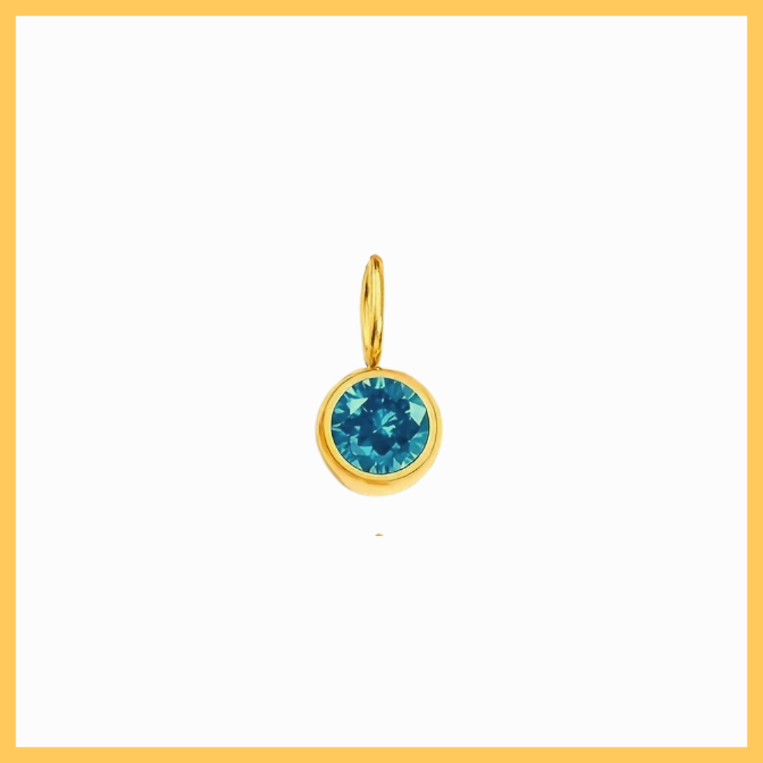 Gold pendant with a blue gemstone on a white background
