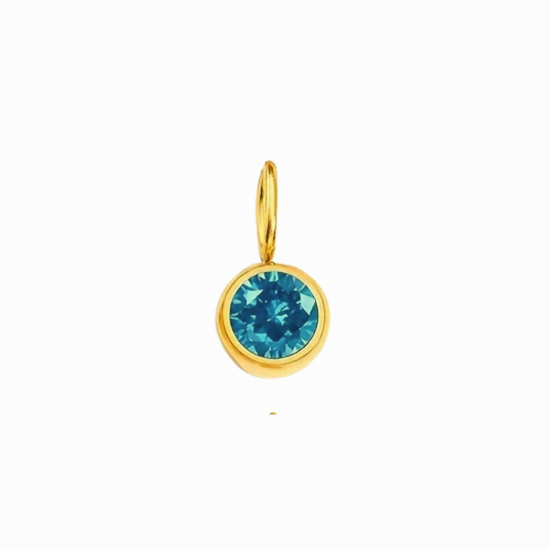 Gold pendant with a blue gemstone on a white background
